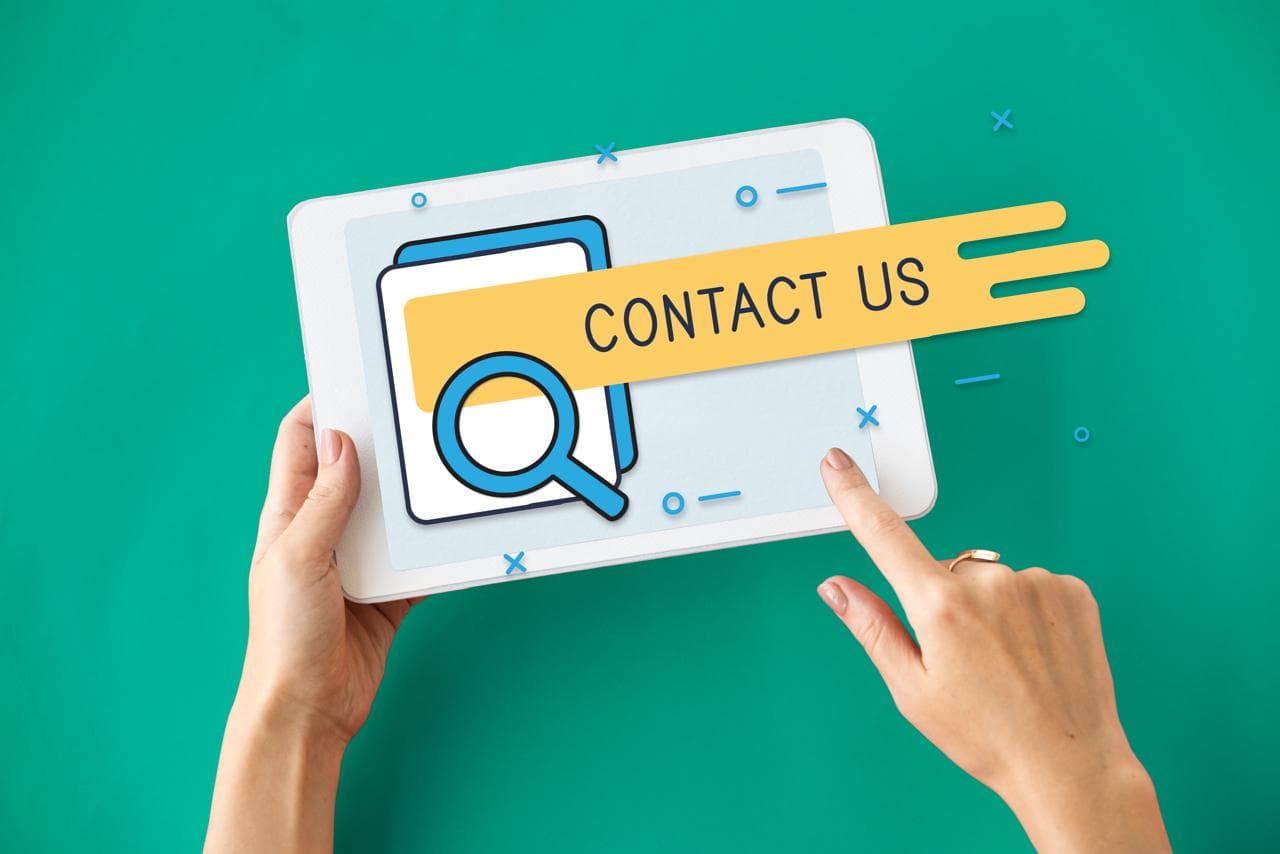 A friendly member of the MG Care team wearing a headset and smiling warmly